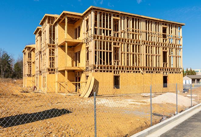 workers protected by temporary barrier fence during building maintenance in Depew NY